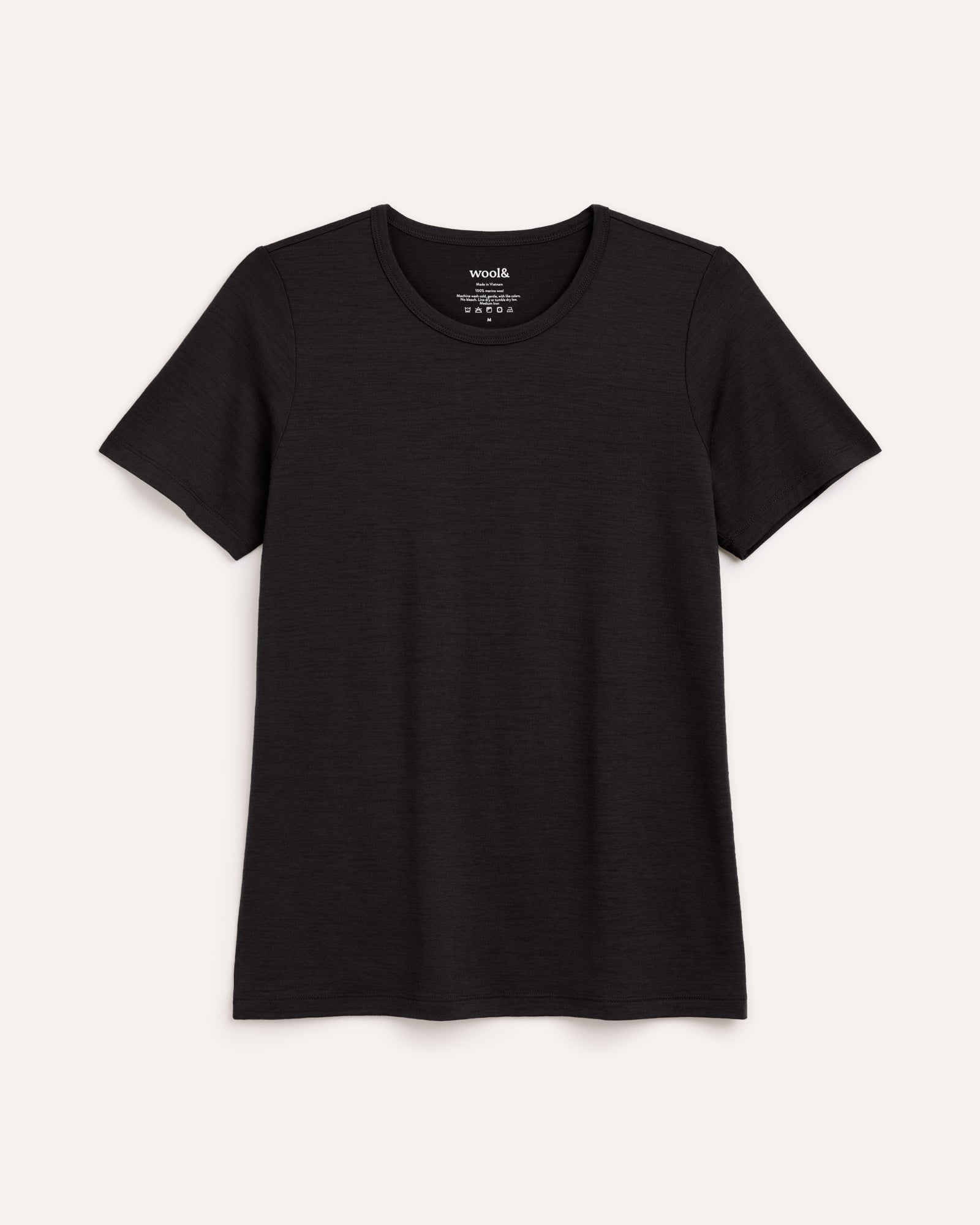 Laydown of Cara 100% Wool Fitted Tee in Black. Cara 100% Wool Fitted Tee is a merino wool short sleeve, crew neck, slim fit tee available in sizes XS-3X.