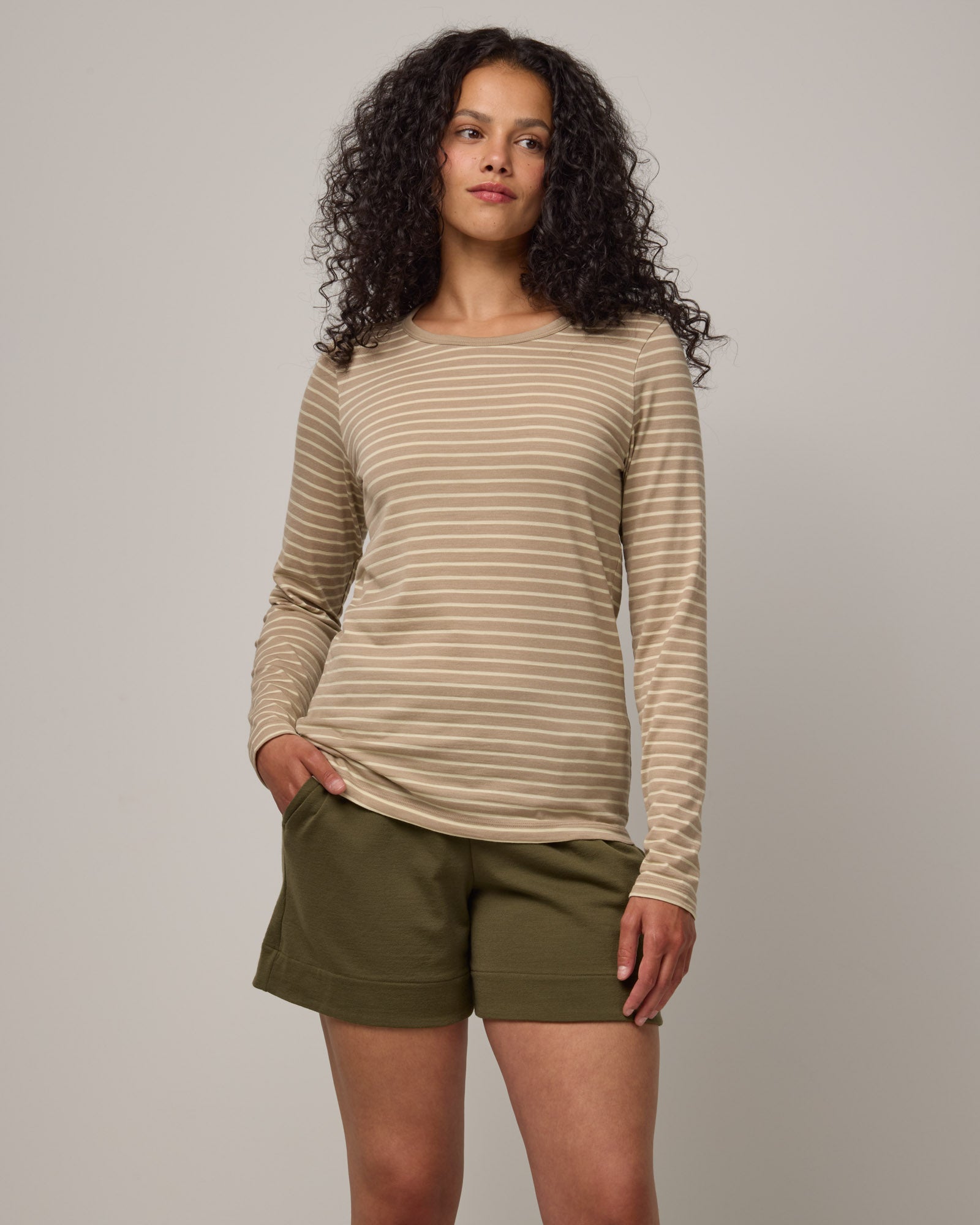 Model wearing Sloan Signature Fitted Tee in Khaki & Natural White Stripe. Sloan Signature Fitted Tee is a merino wool long sleeve, crew neck, slim fit tee available in sizes XS-3X.